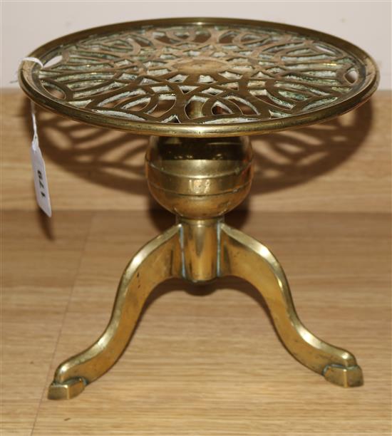 A brass circular trivet